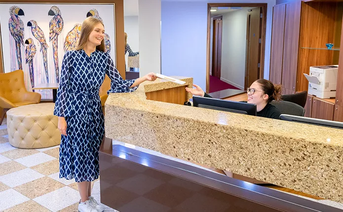 Servcorp receptionist handing mail for client at Mayfair.