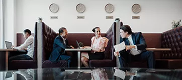 Professionals connect and work in Servcorp’s modern booth lounge.