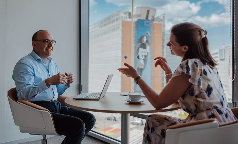 Professionals collaborating in a Servcorp meeting room with Schuman European Quarter views